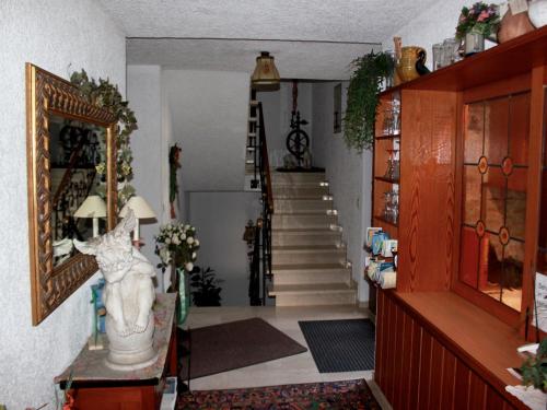a living room with a staircase and a stair case at Gästehaus Mayer-Bartsch in Meersburg