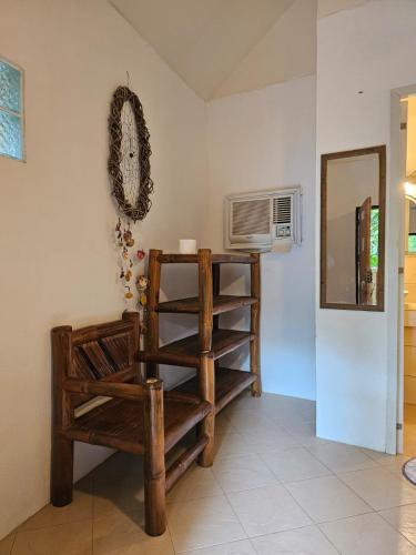 a room with a chair and a clock on the wall at Big BamBoo Beach Resort Sipalay in Sipalay