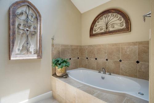 a bathroom with a tub and a window at Travis by AvantStay Waterfront Lake Retreat in Lakeway