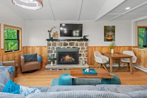 a living room with a couch and a fireplace at Summit Shores Tranquil Escape Designed for Groups w Fire Pit Game Room in Lake Harmony