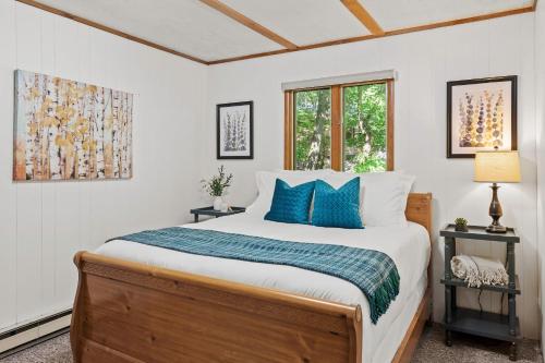 a bedroom with a large bed with blue pillows at Summit Shores Tranquil Escape Designed for Groups w Fire Pit Game Room in Lake Harmony