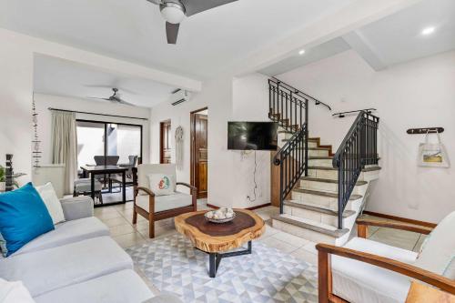 a living room with a couch and a table at Pool Oasis, Concierge & 5min drive to the Beach in Playa Flamingo