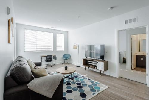 a living room with a couch and a table at Cozysuites l Luxe 2BR in Downtown Cincinnati #2 in Cincinnati