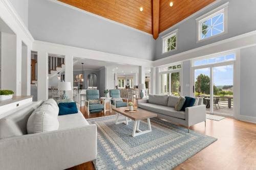 a living room with white couches and a table at Paradise Pointe by AvantStay Lakefront Views Playset in Lake Norman of Catawba