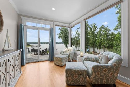 a living room with two chairs and large windows at Paradise Pointe by AvantStay Lakefront Views Playset in Lake Norman of Catawba