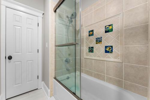 a bathroom with a shower with a glass door at Paradise Pointe by AvantStay Lakefront Views Playset in Lake Norman of Catawba
