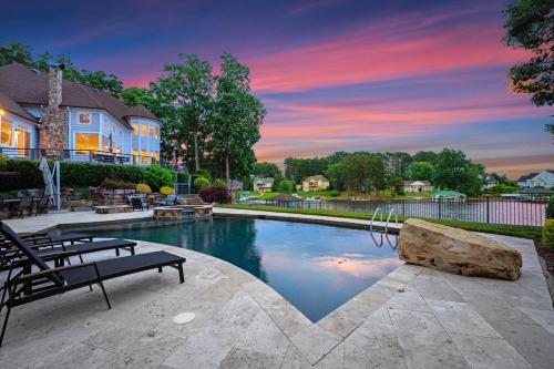 a swimming pool with a bench in a yard at Paradise Pointe by AvantStay Lakefront Views Playset in Lake Norman of Catawba