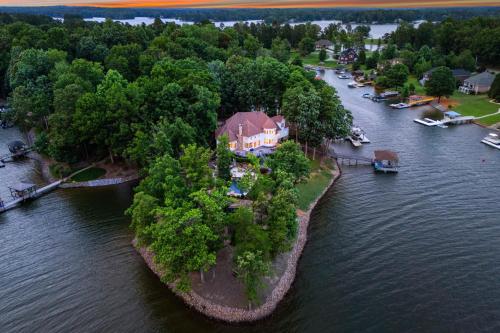 an aerial view of a house on an island in the water at Paradise Pointe by AvantStay Lakefront Views Playset in Lake Norman of Catawba