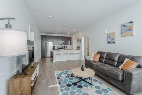 a living room with a couch and a table at Cozysuites l Luxe 2BR in Downtown Cincinnati #2 in Cincinnati