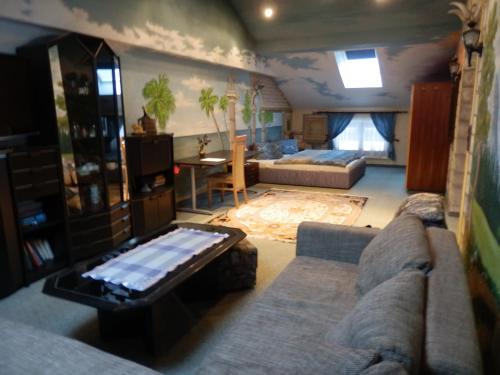a living room with a couch and a table at Reiserhof in Zell am Ziller