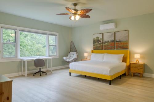 a bedroom with a bed and a ceiling fan at Game Farm Villa by AvantStay 10BDR Private Pond Spa Pool Family-Friendly in Catskill