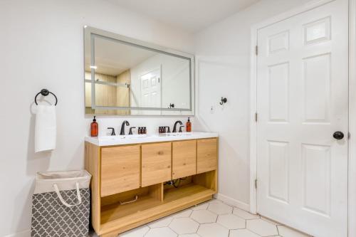 a bathroom with a sink and a mirror at Game Farm Villa by AvantStay 10BDR Private Pond Spa Pool Family-Friendly in Catskill