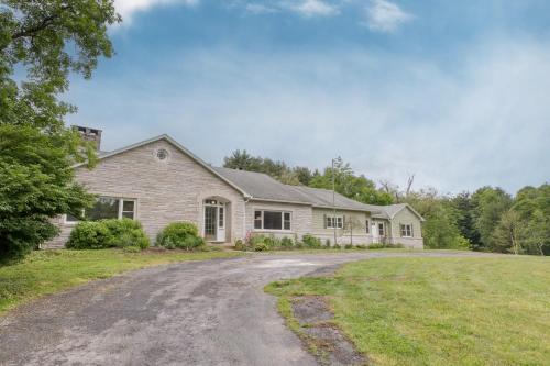a house with a driveway in front of it at Game Farm Villa by AvantStay 10BDR Private Pond Spa Pool Family-Friendly in Catskill