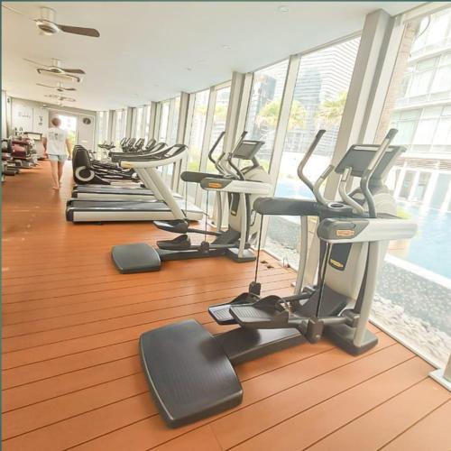 a gym with rows of treadms and cardio machines at Vortex klcc by hr in Kuala Lumpur