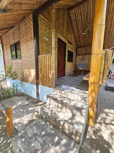 an outside view of a house with a wooden ceiling at Big BamBoo Beach Resort Sipalay in Sipalay