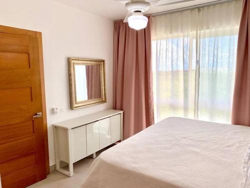 a bedroom with a bed and a mirror and a window at Vibe Gorgeous one bedroom apartment view beach in La Laguna