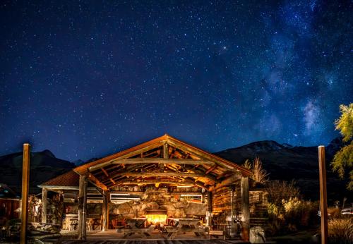 a log cabin with a starry sky at night at The Headwaters Eco Lodge in Glenorchy
