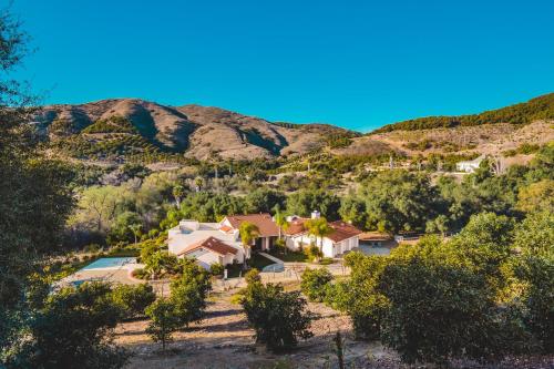 an aerial view of a house in the mountains at Grapevine by AvantStay Secluded 5BR Villa 4 Acres of Vineyards Avo Groves in Temecula