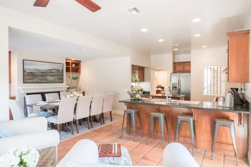 a kitchen and living room with a bar and chairs at Grapevine by AvantStay Secluded 5BR Villa 4 Acres of Vineyards Avo Groves in Temecula