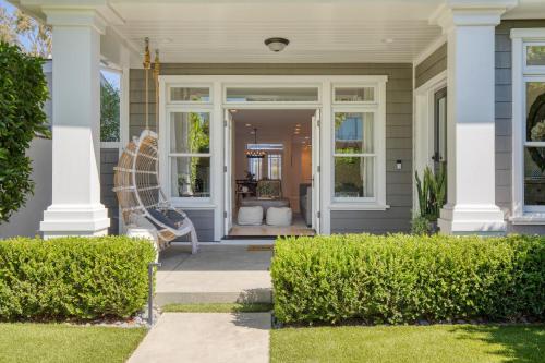 a front porch of a house with a bench at Emerald Cove by AvantStay Mins to Beach Pier in Newport Beach