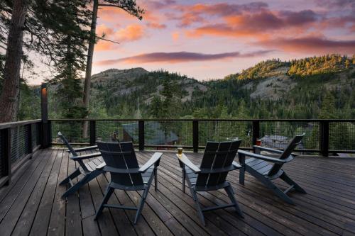 a deck with four chairs and a table with a view at Trapper by AvantStay A Interior Design w Sauna in Alpine Meadows