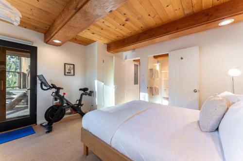 a bedroom with a bed and a bike in a room at Trapper by AvantStay A Interior Design w Sauna in Alpine Meadows