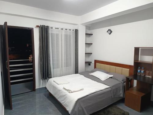 a bedroom with a large bed and a window at Tersha Homestay 2BHK in Shillong