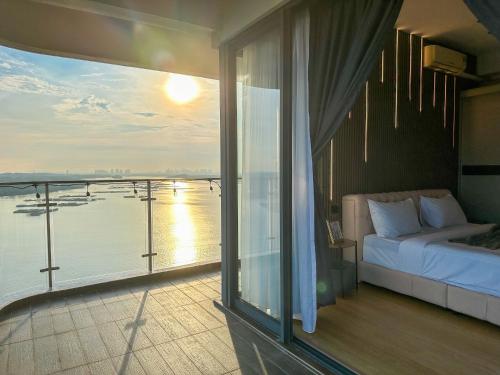a balcony with a bed and a view of the water at Country Garden Seaview Suite by Nest Home at Danga Bay in Johor Bahru