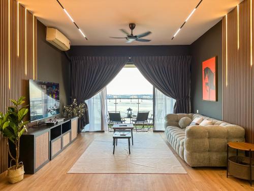 a living room with a couch and a television at Country Garden Seaview Suite by Nest Home at Danga Bay in Johor Bahru