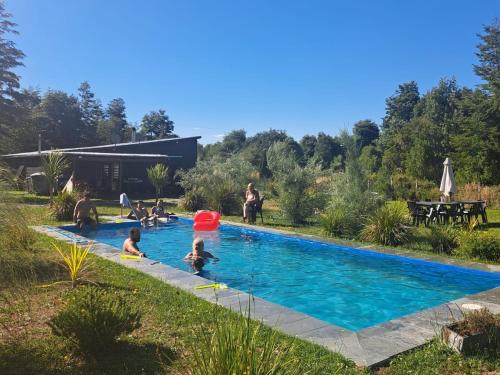 a group of people playing in a swimming pool at Casa campo in Puerto Varas
