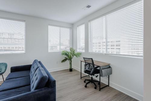 a living room with a blue couch and a table at Cozysuites l Luxe 2BR in Downtown Cincinnati #5 in Cincinnati