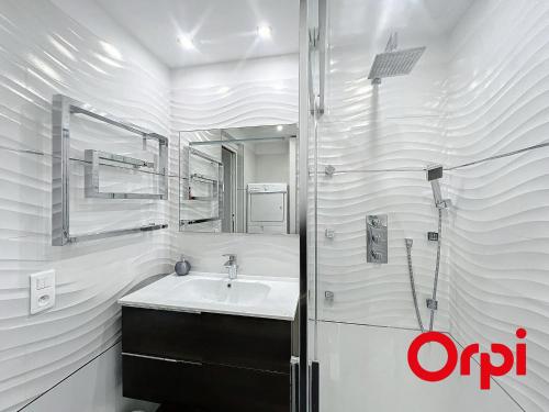 une salle de bain avec un lavabo et un miroir dans l'établissement Superbe 2 pièces avec clim, parking et Wifi - FR-1-647-22, à Menton