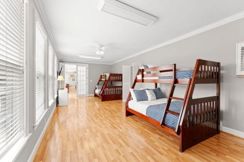 a bedroom with two bunk beds and a hallway at Whitetail Cove by AvantStay Lakefront w Pool Private Dock Sleeps 20 in Terrell