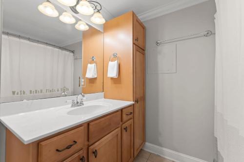 a bathroom with a white sink and a shower at Whitetail Cove by AvantStay Lakefront w Pool Private Dock Sleeps 20 in Terrell