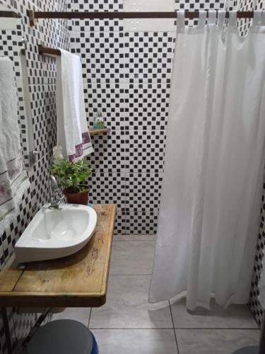 a bathroom with a white sink and a shower at Casa analia in Porto Seguro
