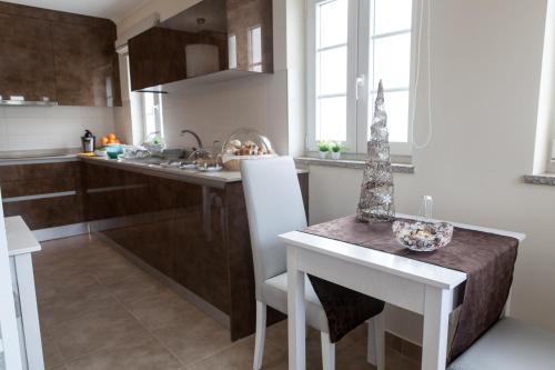 a kitchen with a table and a dining room at Casa d'Avenida in Manteigas