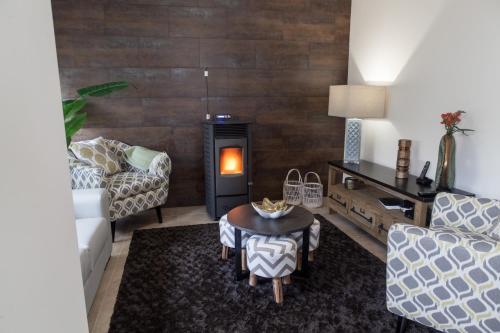a living room with a couch and a table at Casa d'Avenida in Manteigas