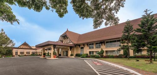 a large building with a driveway in front of it at Taal Vista Hotel in Tagaytay