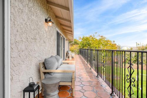a balcony with a bench and a fence at Dume Point by AvantStay Tennis Pool in Malibu in Malibu