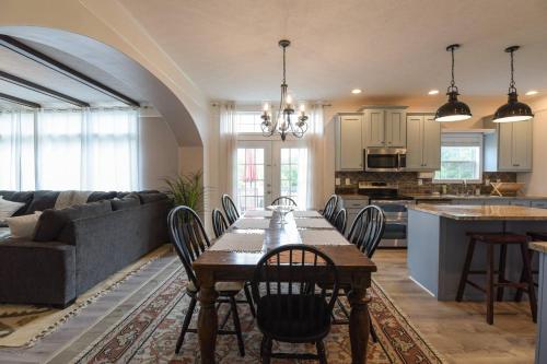 a kitchen and living room with a table and chairs at Riverside Ranch by AvantStay Mins to Downtown in Arden