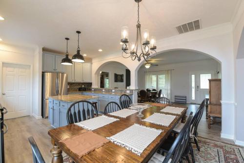 a kitchen and dining room with a table and a dining room at Riverside Ranch by AvantStay Mins to Downtown in Arden