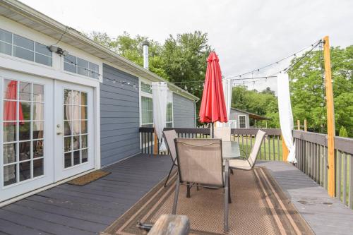 a deck with a table and an umbrella at Riverside Ranch by AvantStay Mins to Downtown in Arden