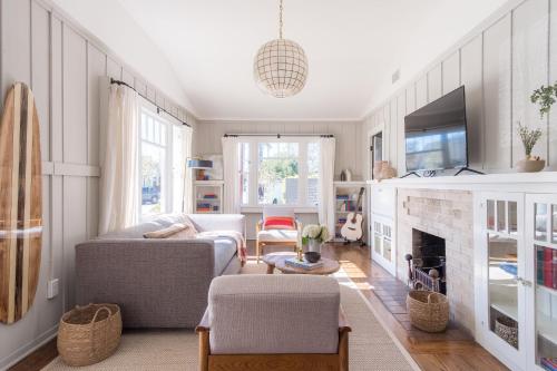a living room with a couch and a fireplace at Topaz By AvantStay Adorable Cottage Walking Distance to Beach w Large Patio in San Diego