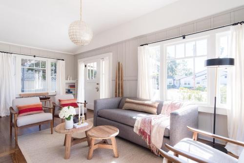 a living room with a couch and a table at Topaz By AvantStay Adorable Cottage Walking Distance to Beach w Large Patio in San Diego