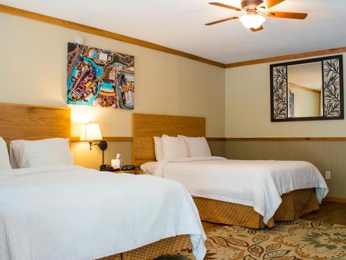a hotel room with two beds and a ceiling fan at The Resort at Schlitterbahn in New Braunfels