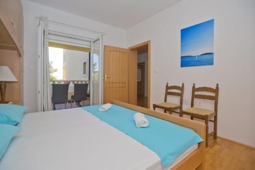 a bedroom with a bed and a table and chairs at Villa Malisko in Hvar