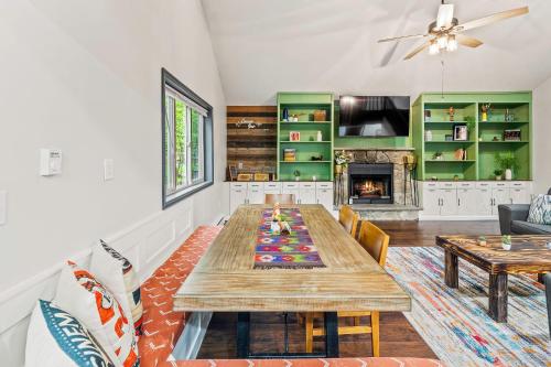 a dining room with a table and a fireplace at The Tranquil Trails by AvantStay Lake Access Deck Fireplace in Albrightsville