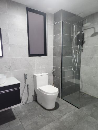 a bathroom with a toilet and a glass shower at The Luxe By MySky Stays at Presint 5, Putrajaya in Putrajaya