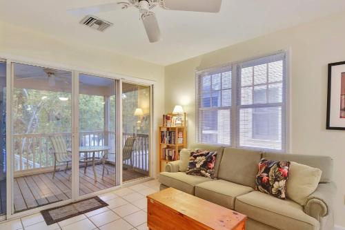 a living room with a couch and a table at A Little Slice Of Paradise by AvantStay Communal Pool Screened in Porch Great Location Month Long Stays in Stock Island
