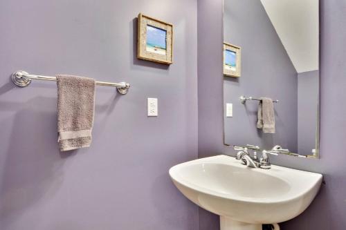 a bathroom with a white sink and a mirror at A Little Slice Of Paradise by AvantStay Communal Pool Screened in Porch Great Location Month Long Stays in Stock Island